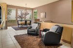 Comfy leather chairs to relax with a view of the open plan living area